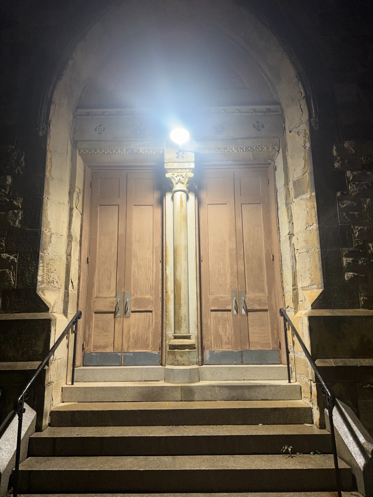 Steps rising to the wooden church doors