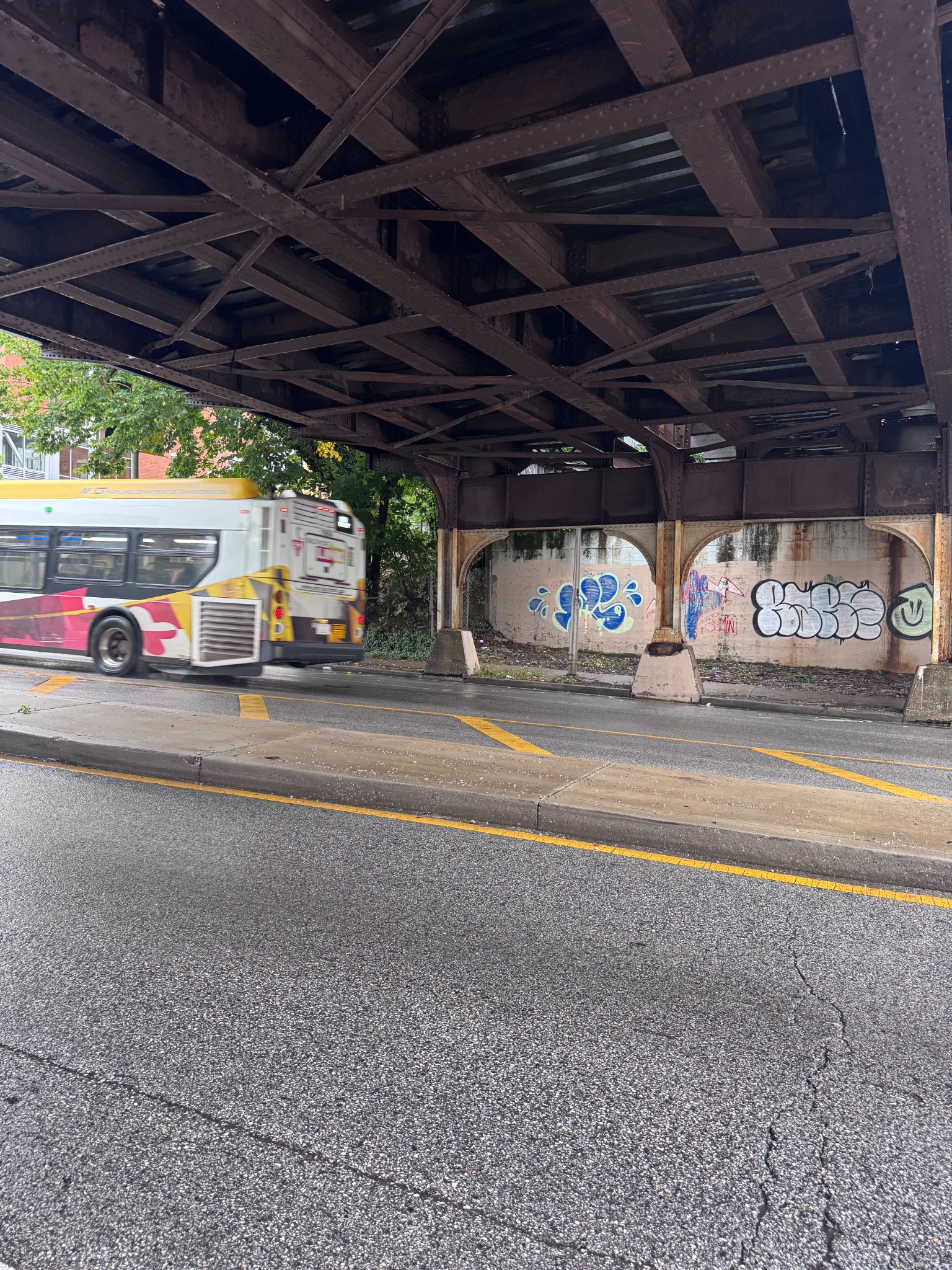 Bus leaving the frame beneath the steel bridge